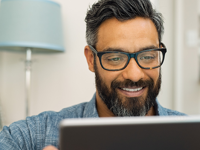 Close up of middle aged man looking at computer screen