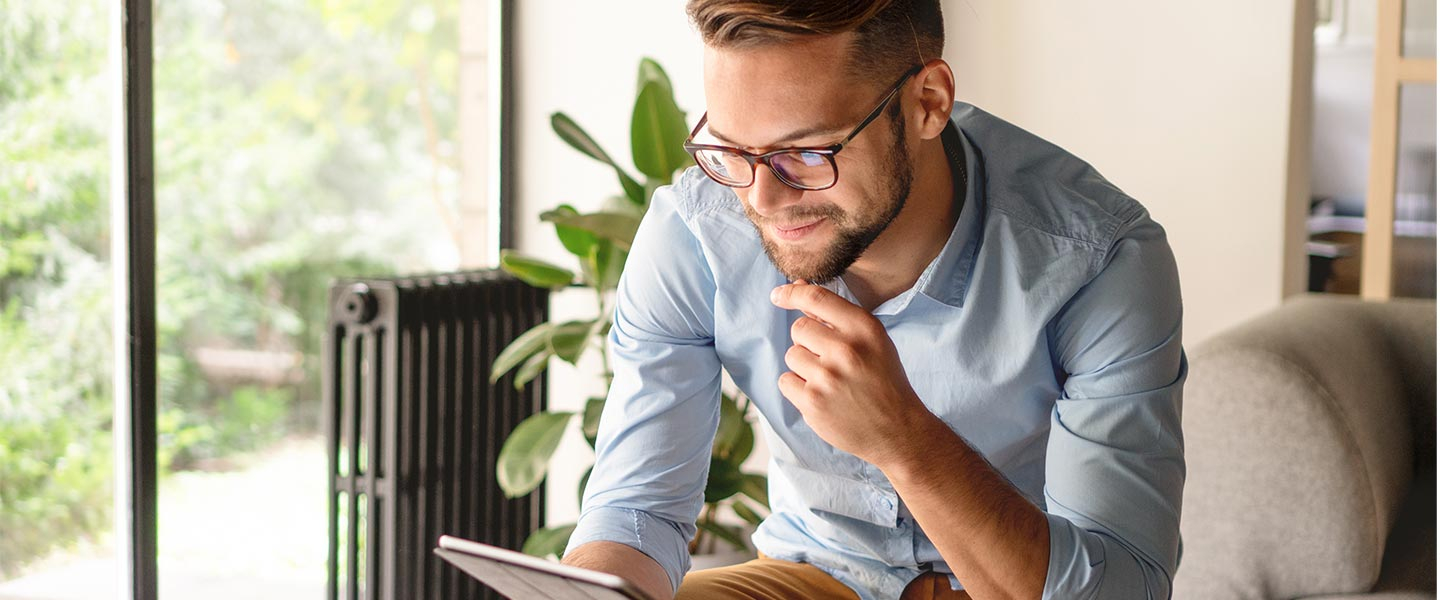 Man sitting looking at tablet