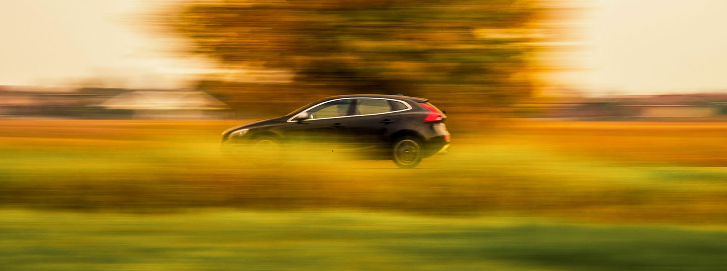 Fast-moving car driving in the countryside