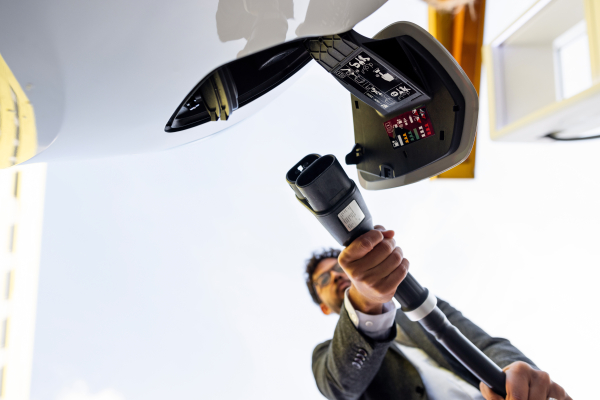 Someone connecting an electric car charger