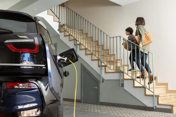 Someone connecting an electric car charger